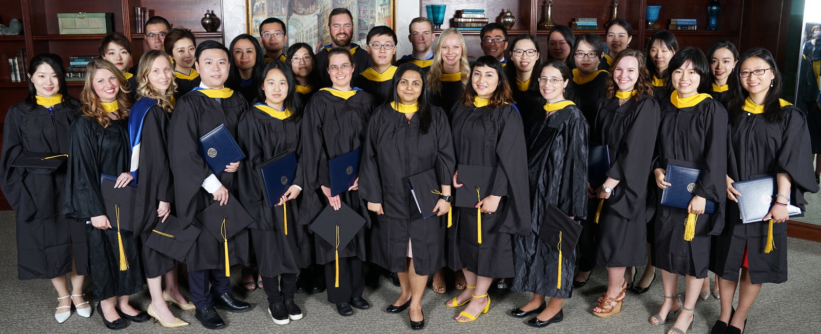 Master Of Biostatistics Class Of 2017 wearing gowns, holding caps and diplomas