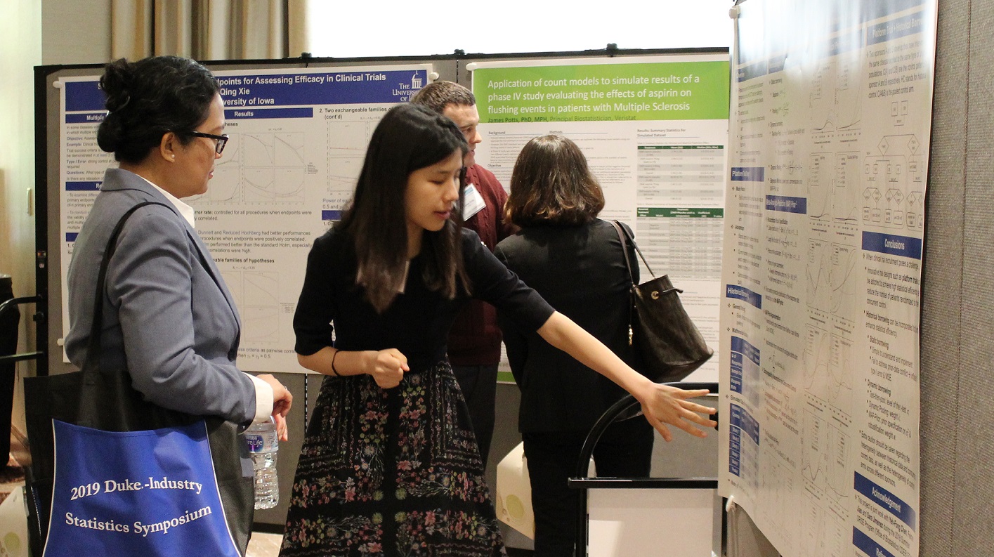 Wenda Tu discusses her winning poster with Dr. Marlina Nasution, of PAREXEL