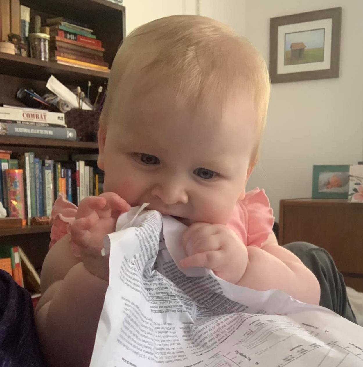 child with paper in her mouth