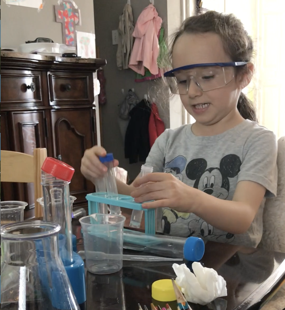 child using science experiment equipment