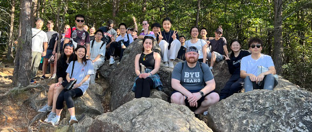 students pose for a photo during a hike in the woods