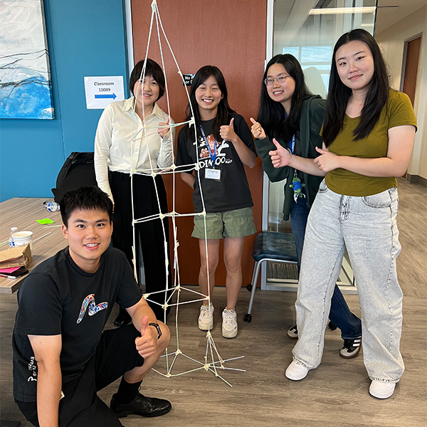 Master of Biostatistics students posing in front of their project.