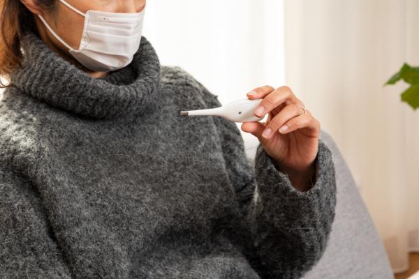 Woman holding thermometer