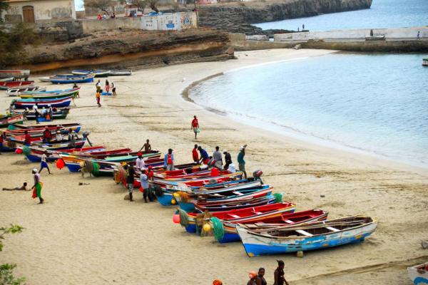 boats and people on beach of Cabo Verde