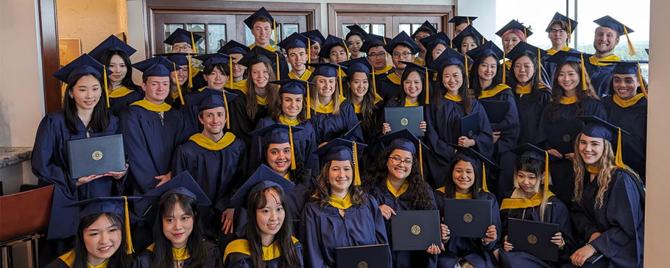 Informal class photo of graduates in their regalia