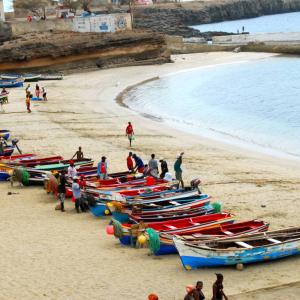 boats and people on beach of Cabo Verde